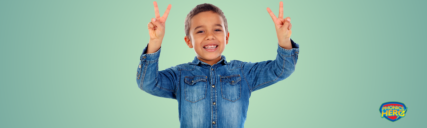 A boy holding up four fingers while talking
