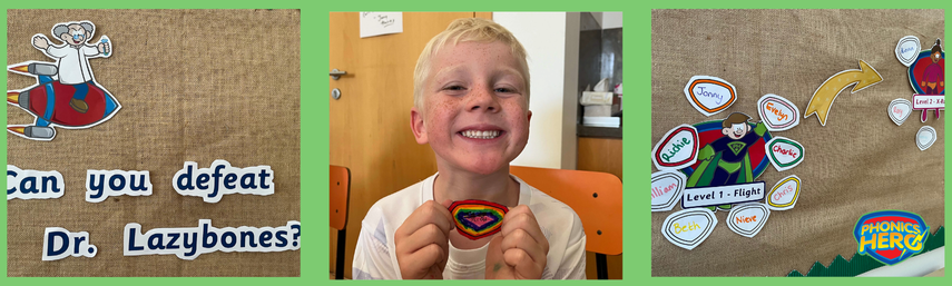 The wall display with Dr Lazybones, a boy holding his name shield and the superhero section