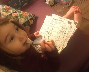 Childing completing phonics activities worksheets